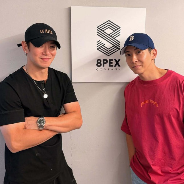 Fly to the Sky members Brian and Hwanhee standing beside an 8PEX Company sign